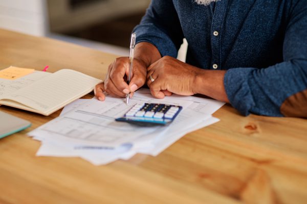 man working at a desk with calculator